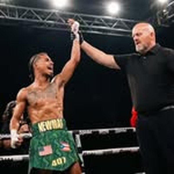 Julian Newman having his hand raised after a boxing win